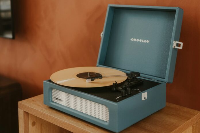 Photo by Clay Banks A blue record player with a record on it.